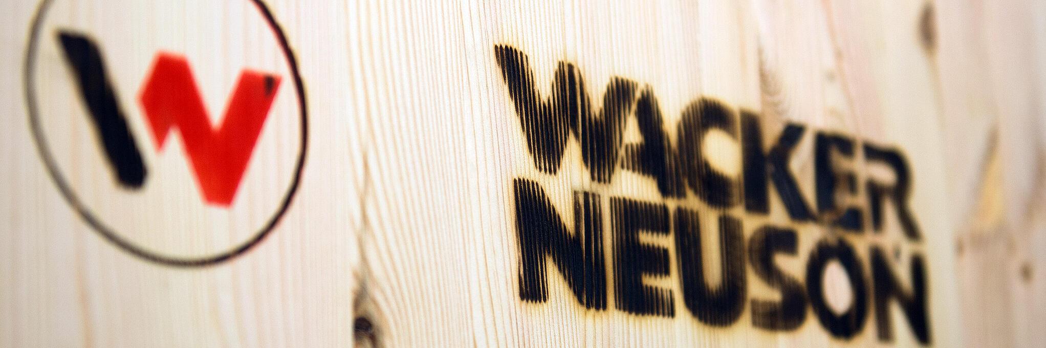 Két logó van egy fafelületre rányomtatva