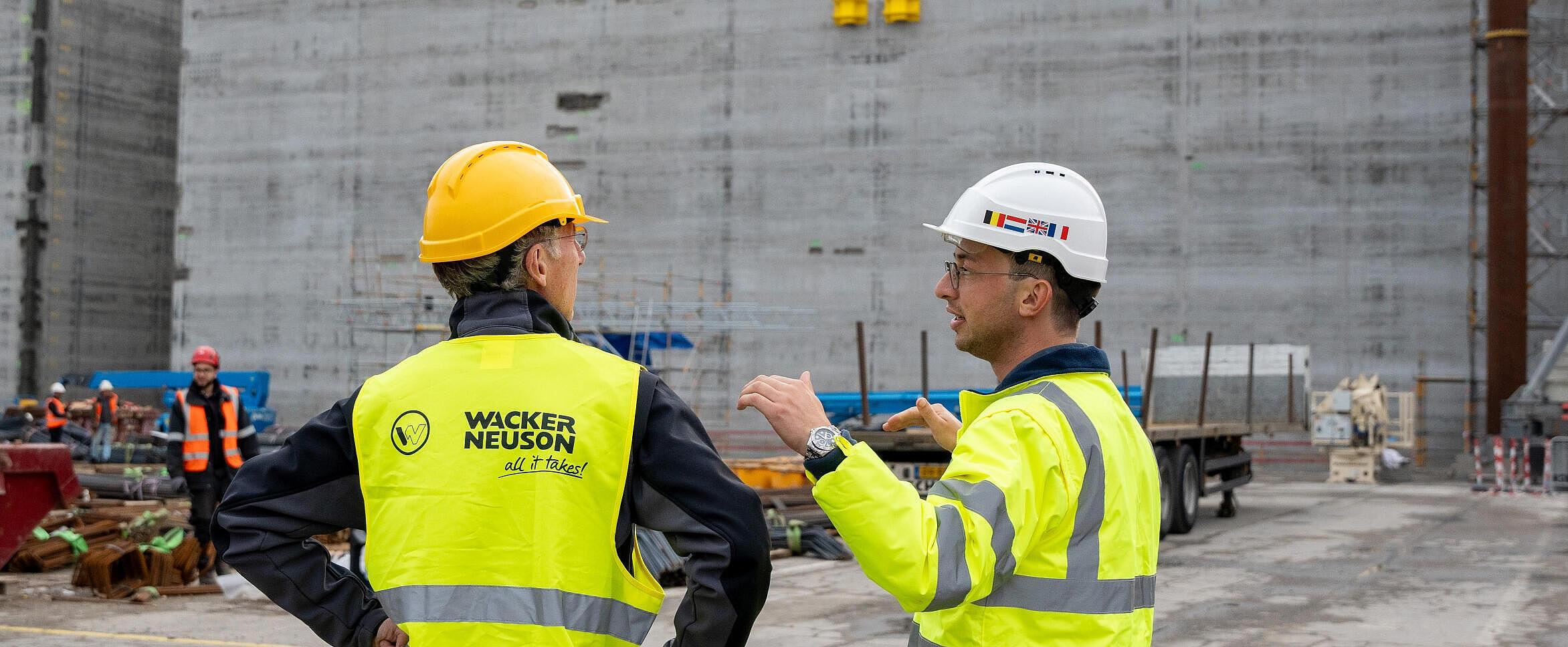 two persons standing in front of concrete element